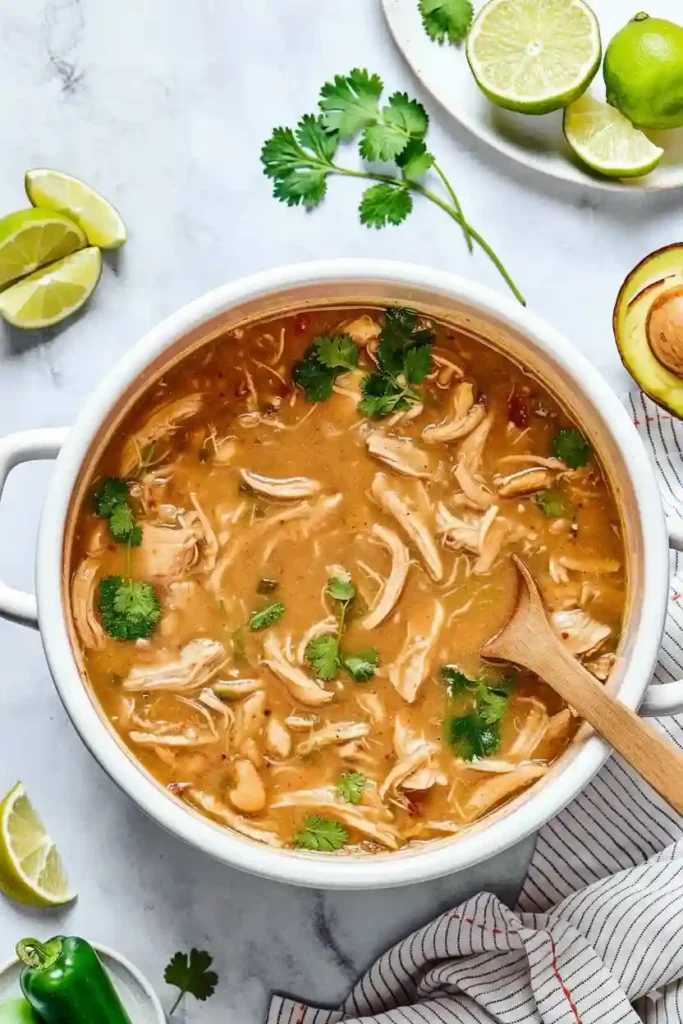 The Best White Chicken Chili  5 A pot of White Chicken Chili recipe no corn with shredded chicken, beans, and fresh cilantro.
