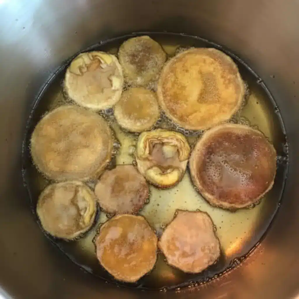 Stuffed Artichoke Bottoms Made Easy with One Great Recipe 11 Artichoke bottoms boiling in water for stuffed artichoke bottoms recipe.