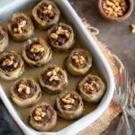 Baked stuffed artichoke bottoms with meat filling and walnuts.