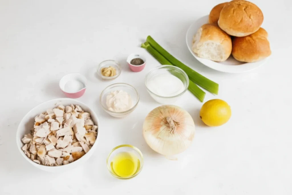 Chicken Salad Sliders Made Easy and So Delicious 4 Ingredients for chicken salad sliders arranged on a white surface.